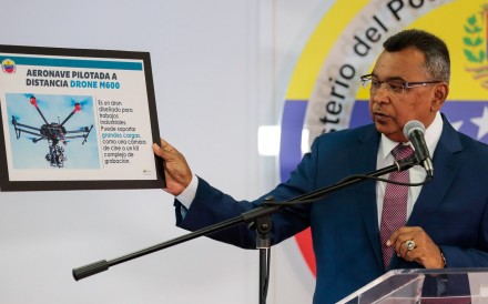 Venezuela's Interior and Justice Minister Nestor Reverol holds a placard with a picture of a drone during a news conference in Caracas about the drone attack on President Nicolas Maduro. Photo: Reuters.