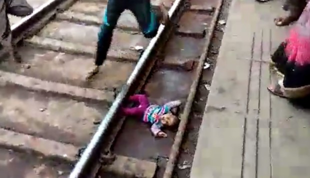 Baby girl dropped onto railway tracks in India survives being run over