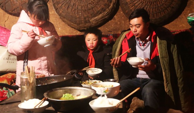 Wang Fuman at home with his sister, Fumei, and father Gangkui.