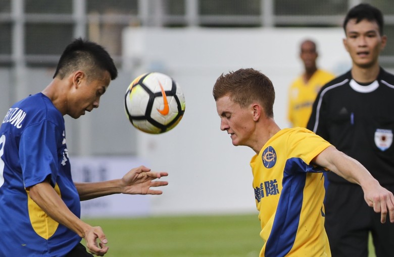 Derek Leung and Chad Schofield compete for the ball at Mong Kong Stadium. Photos: Edward Wong