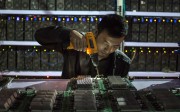 Nearly 70 per cent of all new bitcoin are mined in China in warehouses where massive numbers of microprocessors are used to solve complex maths problems, rewarding miners with the digital currency. Photo: EPA