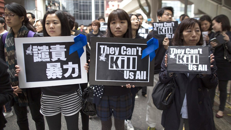 'They can't kill us all' Thousands protest chopper attack on Ming Pao