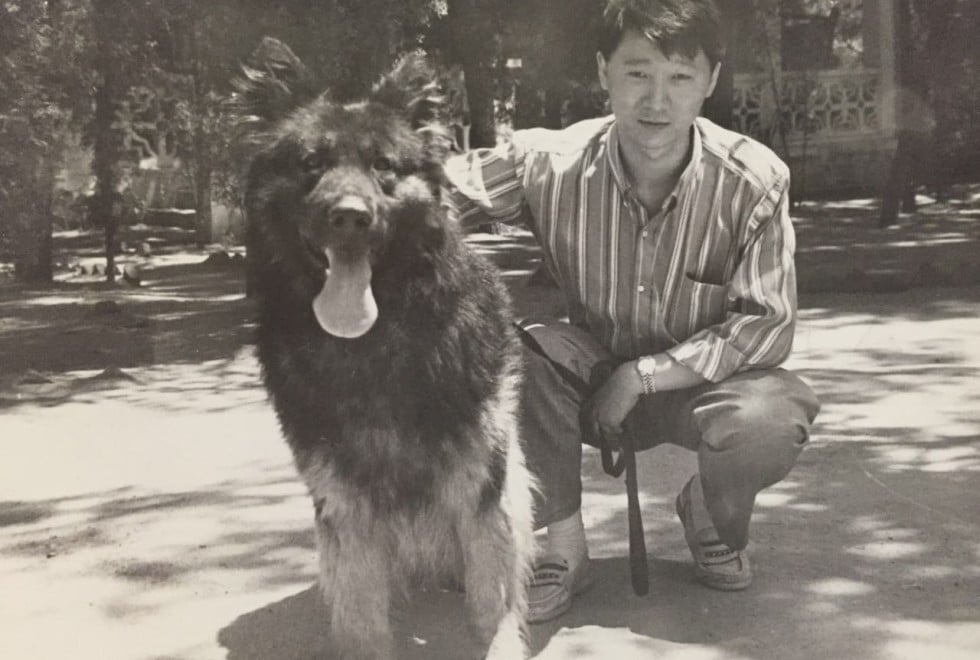 Ma Baoli poses with a dog when he was a young police cadet in the early 1990s.