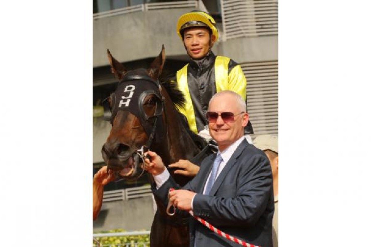 Jockey Howard Cheng and trainer David Hall enjoy the spotlight after Jun Dao's third victory from five starts. Photo: Kenneth Chan
