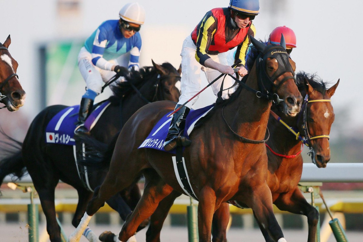 English jockey Ryan Moore on Japanese horse Gentildonna crosses the finish line. Photo: AFP