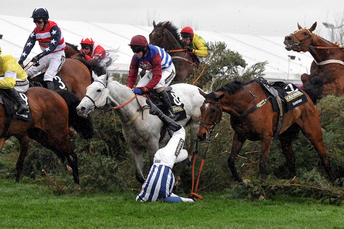 Jockey Nick Scholfield is thrown off joint favourite Teaforthree at The Chair during the running of the Grand National at Aintree. Photo: AFP