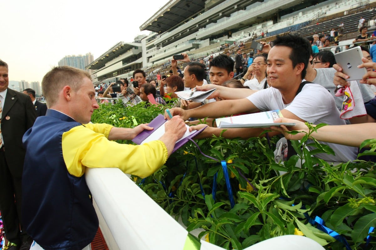 Zac Purton signs autographs as the newly-crowned champion jockey. Photos: Kenneth Chan