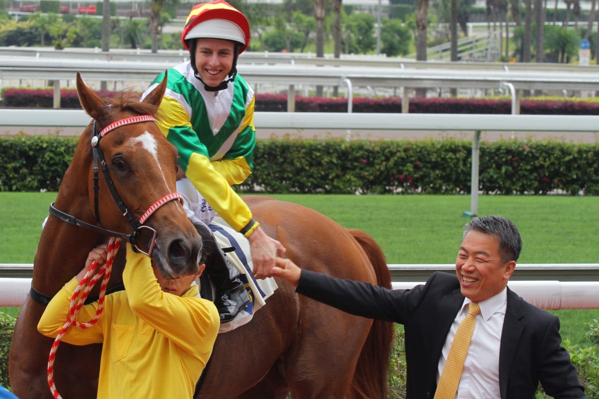 Ricky Yiu congratulates Damian Lane after the Australian jockey won his first Hong Kong race on Happy Chappy. Photo: Kenneth Chan