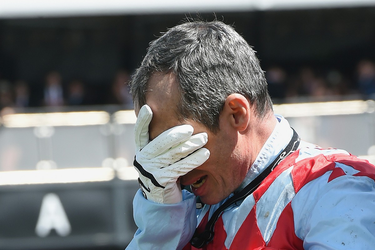 A distraught Gerald Mosse is inconsolable after Red Cadeaux broke down in the Melbourne Cup. This picture tells the story of the race, and of racing in general, as much as any other picture taken on the day. Photo: AP 