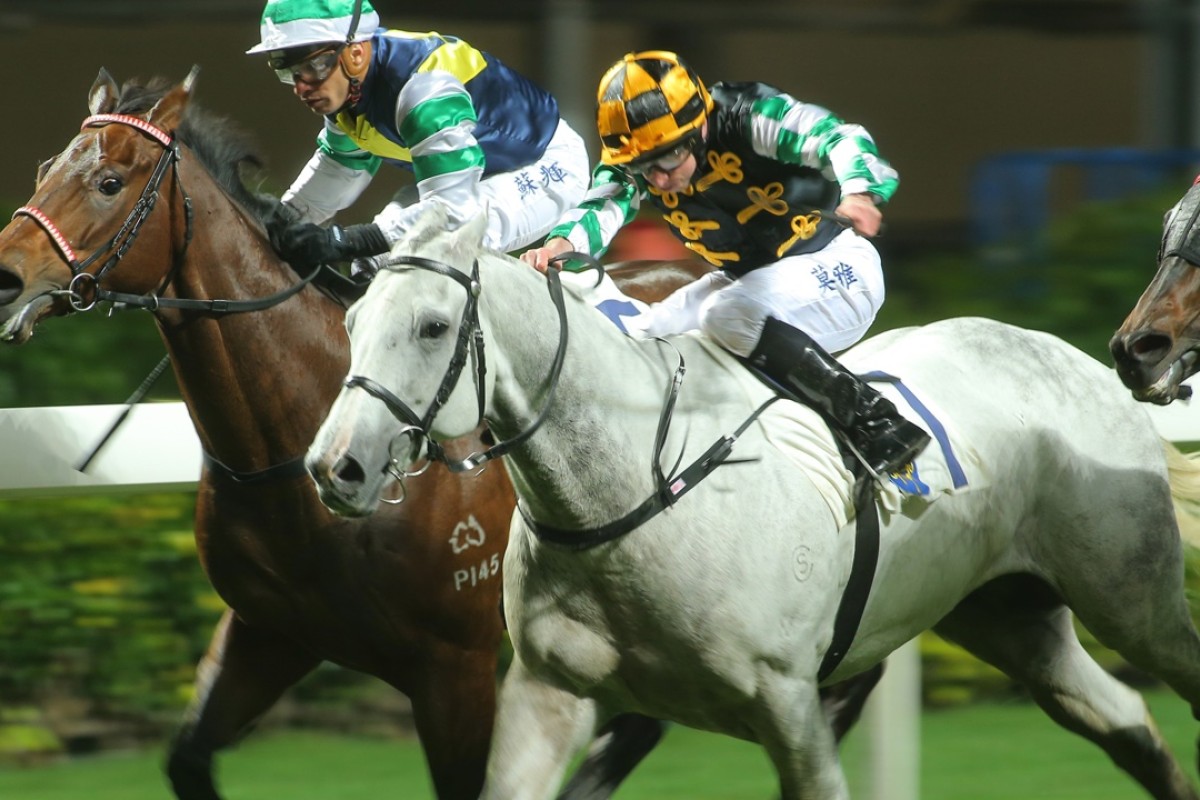 Silver Dragon (centre), ridden by Ryan Moore, hits the line to win race two. Photos: Kenneth Chan