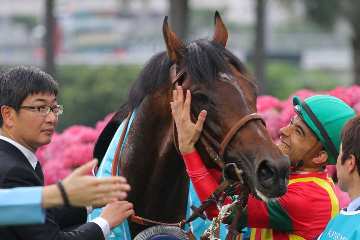 Trainer Noriyuki Hori (left) looks on as Joao Moreira gives Maurice a pat after winning the Champions Mile. Photos: Kenneth Chan