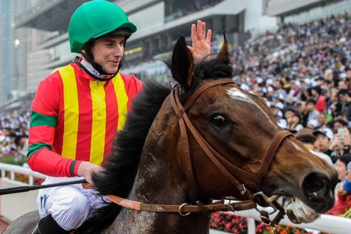 Jockey Ryan Moore waves to the crowd after winning the 2015 Hong Kong Mile with Maurice. Photo: AFP/ANTHONY WALLACE