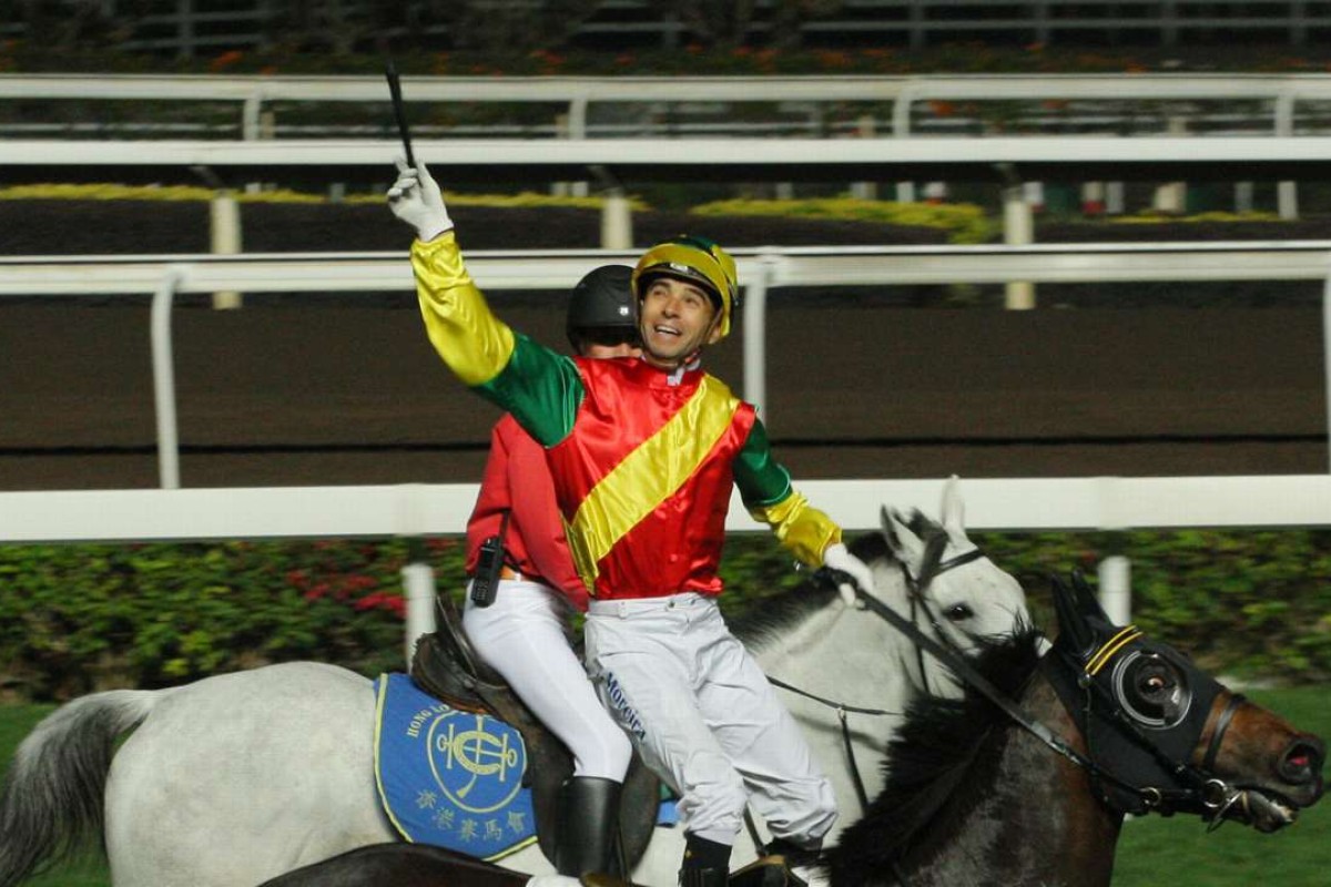 Joao Moreira throws his whip in delight after winning on Grand Harbour. Photos: Kenneth Chan