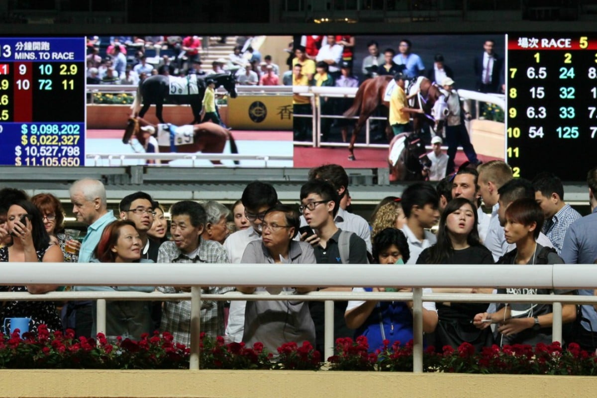 Racing fans line up for a view of the horses at Happy Valley – investment in “customers” is paying dividends for the Jockey Club, says chief executive Winfried Engelbrecht-Bresges. Photos: Kenneth Chan