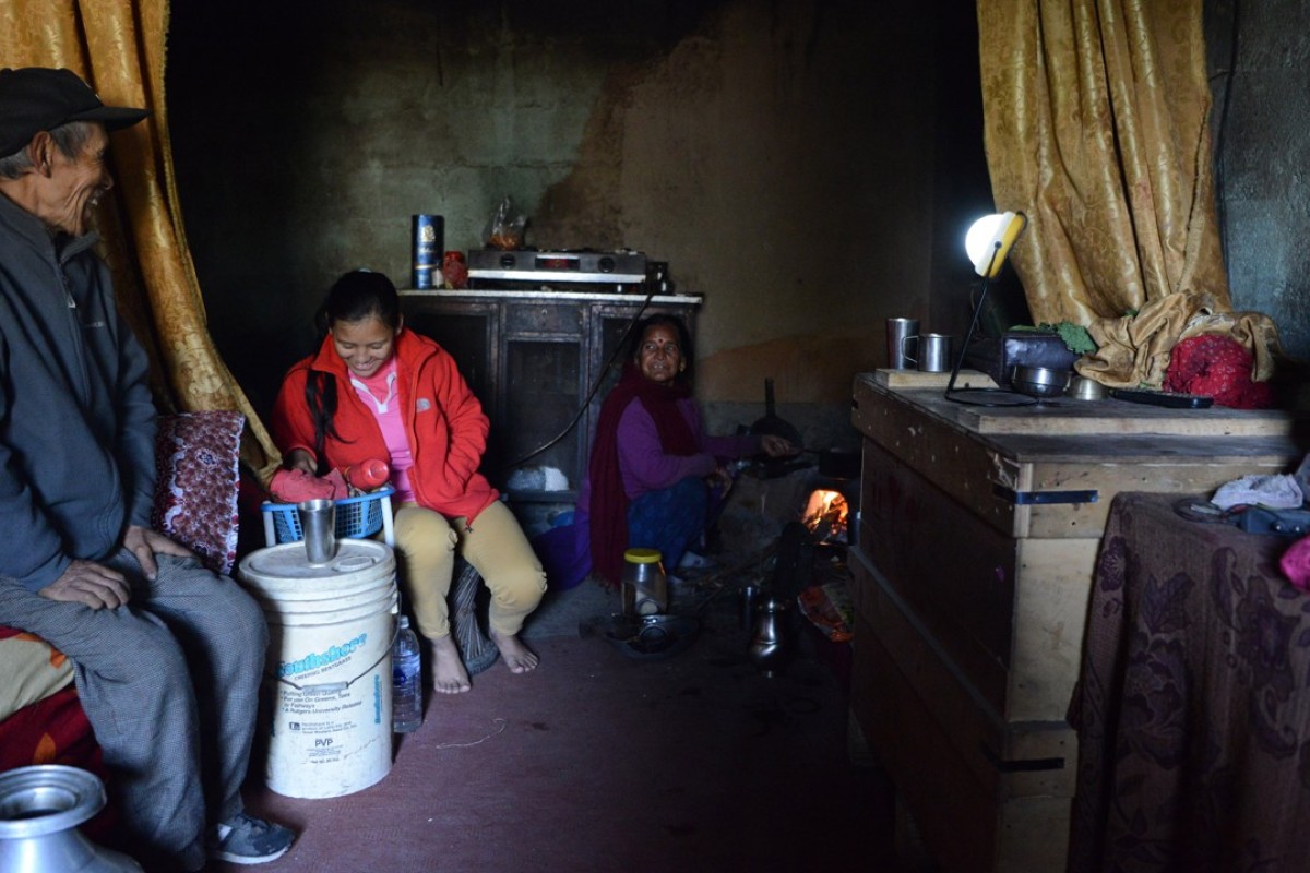 Pratima Sherpa (second from left) is watched by her parents as she does household chores at their home in Kathmandu. Pictures: AFP