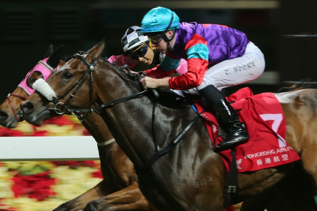 Tommy Berry guides Singapore Sling to victory at Happy Valley on Wednesday night. Photo: Kenneth Chan