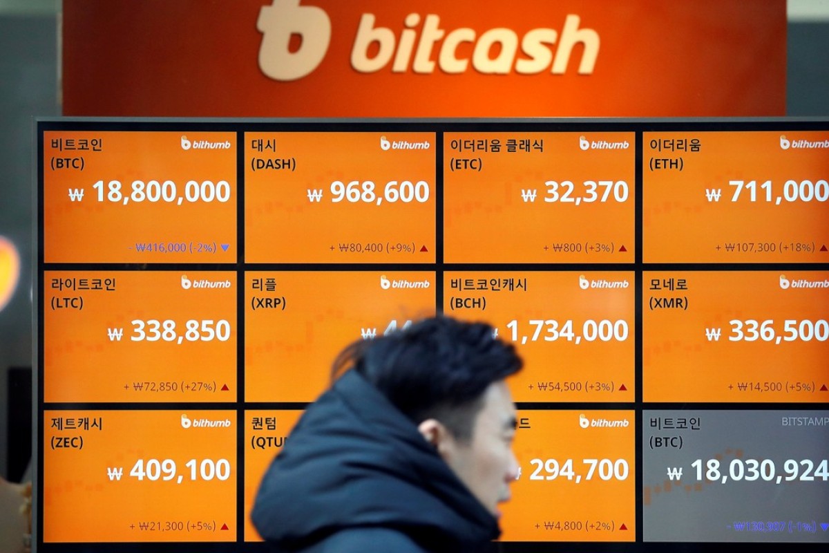 A man walks past an electric board showing exchange rates of various cryptocurrencies including bitcoin at a cryptocurrencies exchange in Seoul. Photo: Reuters