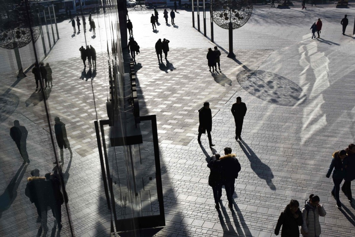 People outside a shopping centre in Beijing. China’s economy beat forecasts to grow 6.9 per cent in 2017. Photo: AFP