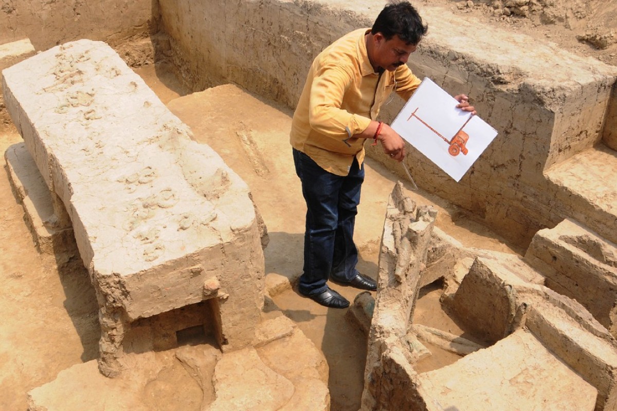 An archaeologist looks at the remains of a chariot belonging to the Indus Valley civilisation at an excavation site in Baghpat. Photo: AFP